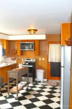 Kitchen with door leading to the utility room.