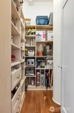 Large walk-in pantry complements extensive cabinetry and storage