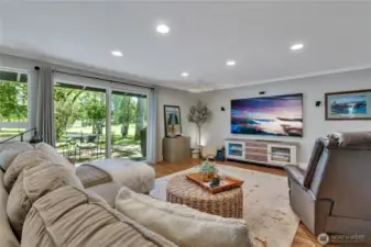 Family room with slider to deck, back yard and golf course.  Room for GameDay size TV!!!  LVP for ease in here as well!