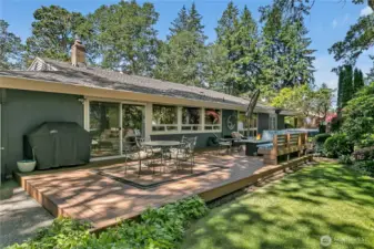 Entirety of nearly 1000 sq. ft. deck.  Natural gas plumbed for barbeque, generous seating areas, pond with waterfall, hot tub, and more! Golf cart garage just to left out of picture.