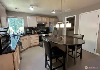 Kitchen - view from sliding glass door area shows center island and pantry area.