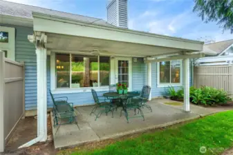Covered patio provides a shaded, inviting space for entertaining guests.