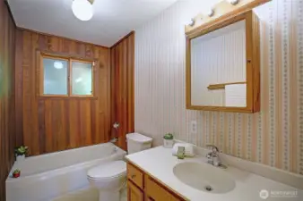 Soft natural light filters into the hallway bathroom where you can indulge in a warm soak that beckons at the end of a long day.
