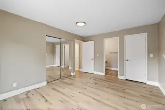 Primary bedroom with attached 1/2 bath and two closets