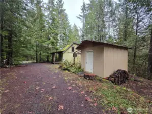 shed with cabin behind it