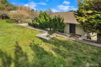 The partially fenced backyard is waiting for your summer games or green thumb.