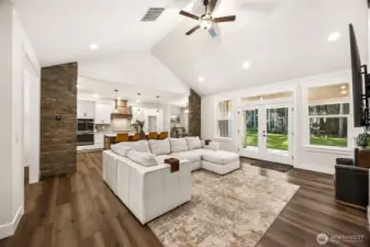 French doors in the family room lead to the covered patio and fully-fenced back yard. Abundant natural light floods this home yet the towering evergreens around the perimeter provide privacy.