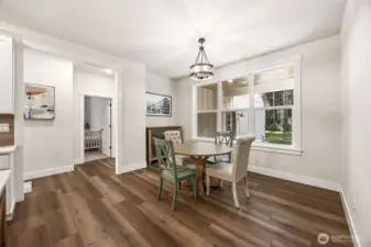 Dining nook, just off the kitchen & family room faces covered back patio & yard. Hallway leads to 2 bedrooms adjoined by a full bathroom, laundry room, an exit to side yard and garage.