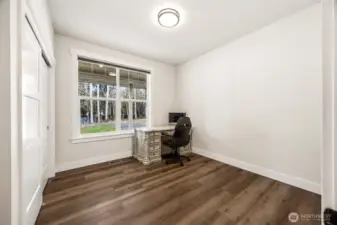 Bedroom #2 (currently used as office space) with Luxury Vinyl Plank Flooring, faces the front yard.