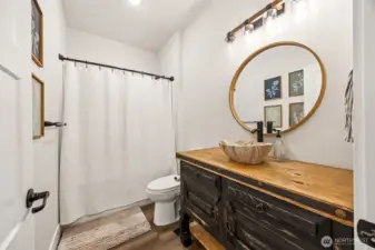 Full bathroom with custom vanity, adjacent to bedroom #3 serves as the main bathroom for the home; conveniently located for guests.