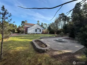 Patio with a fire pit built in. Lots of space for gatherings or just quiet time by the fire.
