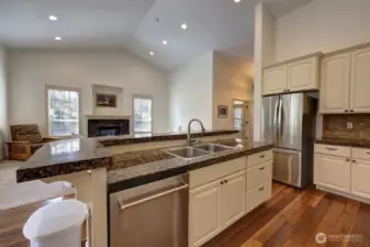 Granite countertops throughout the kitchen. Sink and dishwasher in the island.