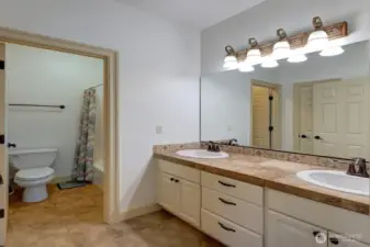 Upstairs bathroom services two guest bedrooms. Double sinks.