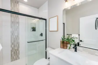 Main floor Guest Bathroom with beautiful tiled shower.