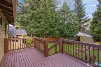 Deck has stairs leading to backyard.