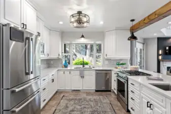 Kitchen offers plenty of cupboard space, stainless fridge.