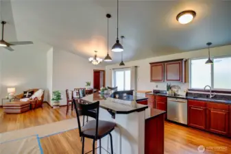 Looking from kitchen into dining area, slider to patio and gazebo area in backyard.  Door beyond dining table leads to a nice mud room area with full closet.