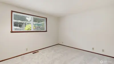 Light-filled primary bedroom with neutral finishes ready for your ideal setup.