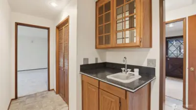 Convenient hallway wet bar area offering extra storage and functionality.