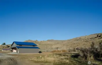 To the right of the neighbor's existing hangar is the 50'X300' easement where you can build your own hangar.