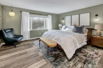En'suite primary bedroom with nature views and peaceful privacy.  Beautifully sized w/remodeled spa bath and custom closets.