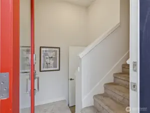 From the main entrance, take the stairs up to the open kitchen and living space, or enter straight ahead to the live/work space