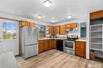 Large kitchen with stainless steel appliances and ample storage space.