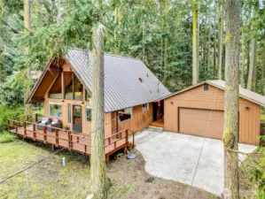 Home and two car detached garage with metal roofs