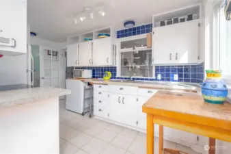 Spacious kitchen, connects the dining/living area and the utility room. The main level bathroom is at the end.