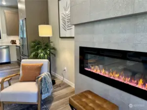 Beautifully tiled wall with electric LED fireplace with heat and 16 different settings.