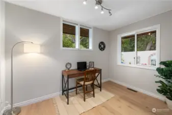 This could be a second bedroom or office on the main level.  The private garden oasis is right out that window.  Its a wonderful serine view!  Brand new flooring and paint.
