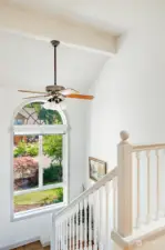 Staircase leads to loft space that overlooks living room.