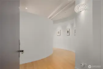 The curve walls at the entry lets you know your in for something special. Wonderful gallery wall.