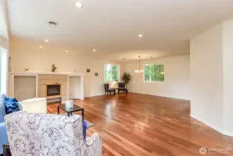 Hardwood floor welcome to open living room with Amish built electric fireplace.