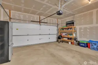 Oversized Two car garage large enough for a work space. Pull down overhead latter for extra storage.