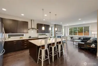 High end finishes include quartz counters, cherry cabinets, stainless appliances, tile fireplace with gas insert, and hardwood flooring.
