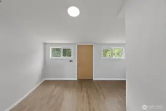 Utility room with door leading to back deck.