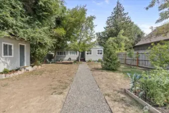 Garden area with storage shed. Mature fruit trees and large trees for shade to keep cool.