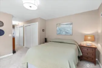 Primary Suite/ Lots of natural light. This room includes a half bath with new sliding door and storage shelf
