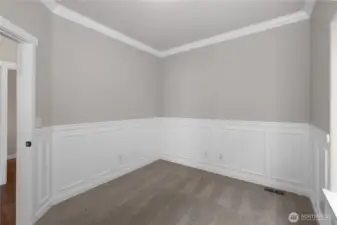 Featuring classis wainscoting, the main-level den provides an excellent office or flex space, with the flexibility to adapt to your family's changing needs.