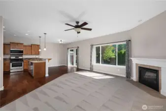 Light filled with high ceilings and plenty of windows, plus siding doors to a cozy covered patio.