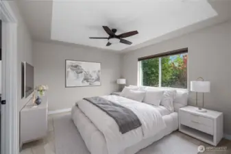 Primary suite features a 5-piece bath, walk-in-closet, ceiling fan, stylish ceiling detail, and brand new carpet. Virtually staged.