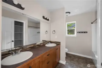 Full size bathroom on the second level, featuring dual sinks for convenience.