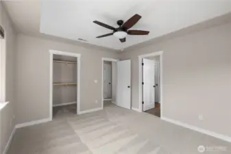Primary suite features a 5-piece bath, walk-in-closet, ceiling fan, stylish ceiling detail, and brand new carpet.