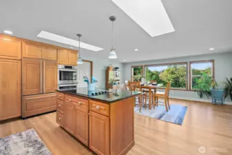 Dream kitchen with Bosch appliances, granite finishes, and open flow to a sun-filled great room
