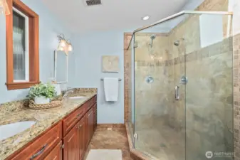 Additional bathroom boasts granite countertops and a spacious double vanity and large shower