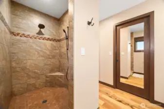Large primary custom tiled shower.