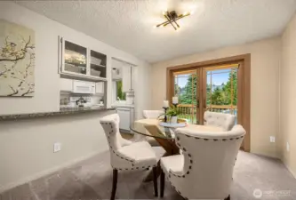 The dining area connects to the expansive deck through French doors, offering an easy transition for indoor–outdoor entertaining.