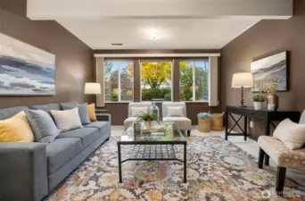 A light-filled lower-level family room combines comfort and versatility, enhanced by a traditional wood-burning fireplace.