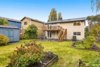 Generous backyard with a deck, patio and garden space for year-round enjoyment.